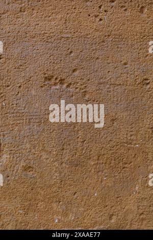 close-up flat photography of an ancient stone wall texture in light terracotta colour Stock Photo