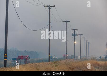 Cal Fire teams search for access to to spot fires behind a fenced ...