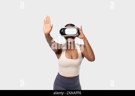 Woman Wearing Virtual Reality Headset Interacting With Digital World Stock Photo