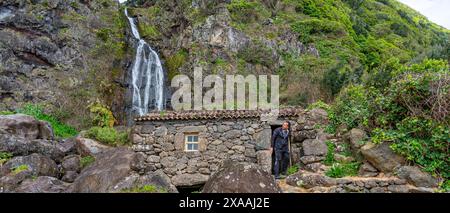 waterfall and small rustic house next to the Fajã dos Bodes waterfall-São Jorge Island-Azores-Portugal. Stock Photo