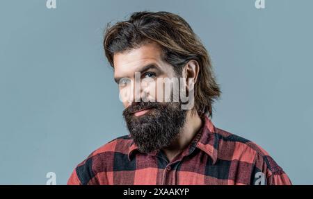 Shampoo conditioner for men. Expert care for demanding hair. Plastic container with shampoo. Young handsome man applying cream lotion. Man holds Stock Photo