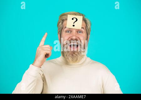 Man with question mark on forehead. Paper notes with question marks. Beard man question mark in head, solution problems. Thinking man with question Stock Photo