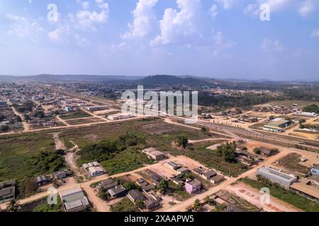 Aerial drone view of Novo Progresso city skyline, dirty streets, squares and BR-163 road. Amazon rainforest in the background on summer day. Pará Stock Photo