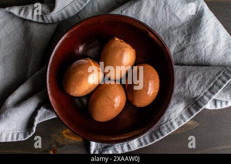 Overhead View of Soy Sauce Eggs in a Wooden Bowl: Soft-boiled eggs that have marinated in a spiced soy sauce marinade Stock Photo