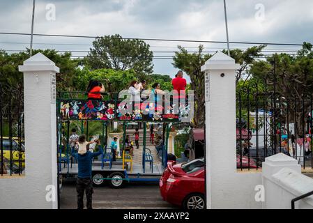 Tourist bus passing in front of Church at the Central Square, Juayúa, town on Ruta de las Flores, El Salvador Stock Photo