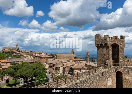 A beautiful view of the rooftops and skyline of the historic medieval town of Montalcino in Tuscany, Italy on a sunny day with blue sky and clouds. Stock Photo