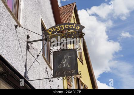 Feuchtwangen, Germany - June 6, 2023: A close-up view of an ornate metal sign hanging outside of a pizzeria in Germany. Stock Photo