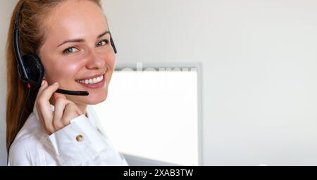 Portrait of happy woman in headset. Customer service online support worker. Helpdesk. Stock Photo