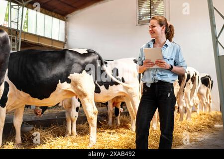 Portrait of happy woman animal farmer in livestock farm. Stock Photo