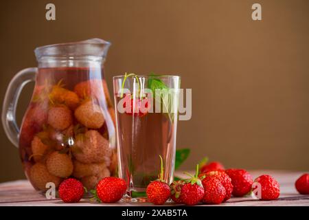 Sweet refreshing berry compote of ripe strawberries in a decanter . Stock Photo