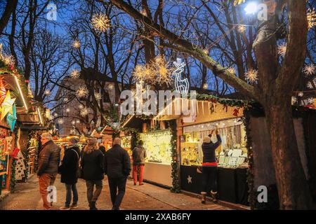 Basel, Switzerland - December 05. 2022: Traditional Christmas market in the evening on the Muenster square with beautiful illumination lights and stre Stock Photo