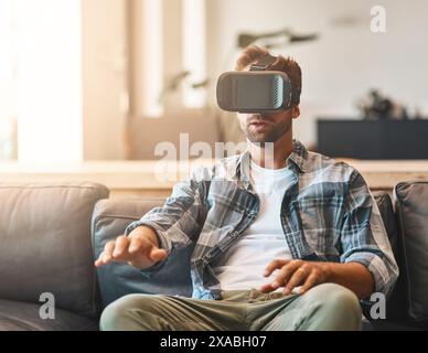 Touch, man and virtual reality headset in home lounge of cyber experience, metaverse system or gaming connection. .Gamer, VR or games in living room Stock Photo