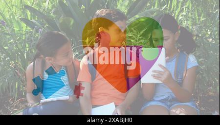Image of colourful puzzle pieces and heart over kids friends using electronic devices Stock Photo