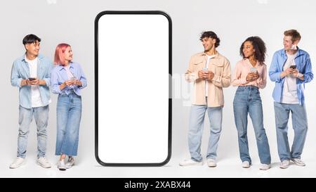 Multiracial Young Adults Using Smartphones Near Giant Phone Mockup Stock Photo