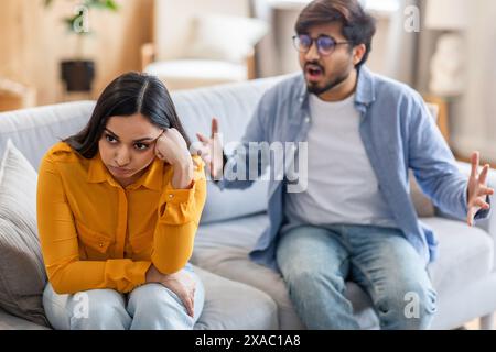 Young Couple Arguing in Living Room During Daytime Stock Photo