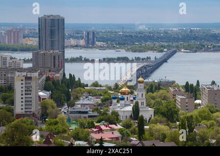 SARATOV, RUSSIA - MAY 03, 2024: Cathedral of the Descent of the Holy Spirit and the bridge over the Volga river in the city landscape on a May morning Stock Photo