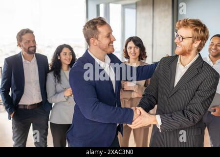 Two Men Business Professionals Shaking Hands In Modern Office Stock Photo