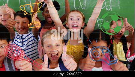 Image of sports concept icons against diverse students showing thumbs up at elementary school Stock Photo