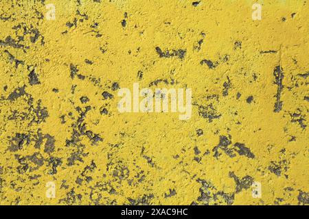 Yellow concrete wall, texture, background. Old textured wall, painted in yellow. Surface of concrete slab or supporting wall Stock Photo