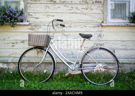 Old bike vintage style background. Vintage bicycle against old rustic wooden wall. Stock Photo