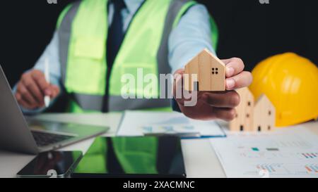 Architect or engineer using tablet to work on table, Construction planning, Structural calculation, Structural design, Project presentation plan, Cons Stock Photo