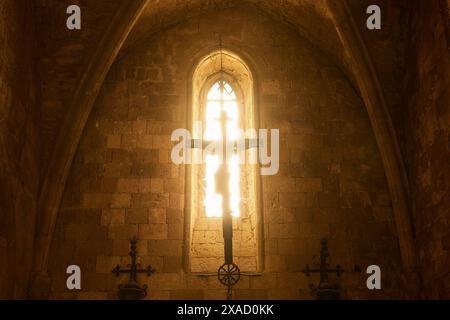 Chancel of the monastery church, window of a church with sunlight on a cross, Gothic style, Monastery of Our Lady of Mount Filerimos, Filerimos, hill Stock Photo