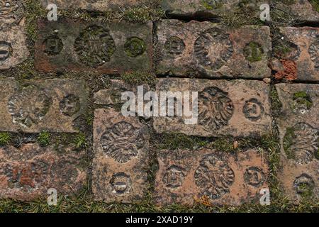 flat photography of an old red brick with marks and initials texture background Stock Photo