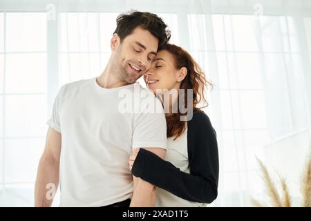 A man and a woman share a tender embrace, connecting intimately in a moment of love and closeness. Stock Photo