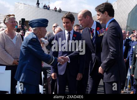 The Prince of Wales meets Richard Rohmer, 100, one of the most decorated Canadian veterans, accompanied by the Prime Minister of France Gabriel Attal and Canadian Prime Minister Justin Trudeau, at the Government of Canada ceremony to mark the 80th anniversary of D-Day, at Juno Beach in Courseulles-sur-Mer, Normandy, France. Picture date: Thursday June 6, 2024. Stock Photo