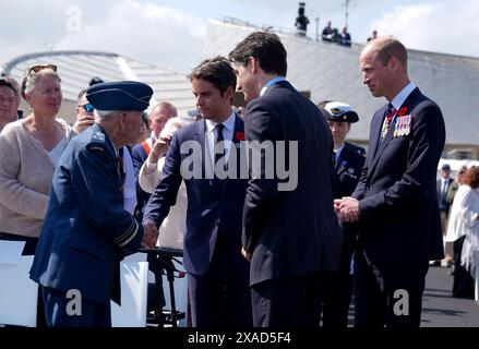 Prime Minister of France Gabriel Attal meets Richard Rohmer, 100, one of the most decorated Canadian veterans, accompanied by the Prince of Wales and Canadian Prime Minister Justin Trudeau, at the Government of Canada ceremony to mark the 80th anniversary of D-Day, at Juno Beach in Courseulles-sur-Mer, Normandy, France. Picture date: Thursday June 6, 2024. Stock Photo