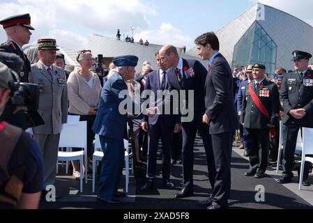 The Prince of Wales meets Richard Rohmer, 100, one of the most decorated Canadian veterans, accompanied by the Prime Minister of France Gabriel Attal and Canadian Prime Minister Justin Trudeau, at the Government of Canada ceremony to mark the 80th anniversary of D-Day, at Juno Beach in Courseulles-sur-Mer, Normandy, France. Picture date: Thursday June 6, 2024. Stock Photo