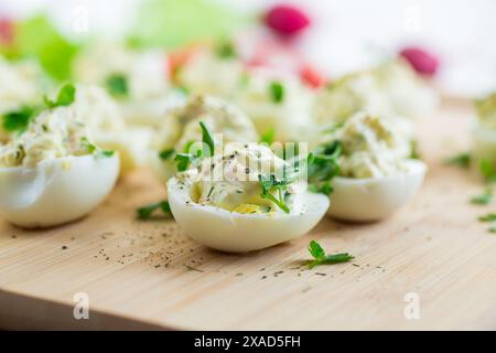 stuffed eggs, deviled eggs on a wooden table . Stock Photo