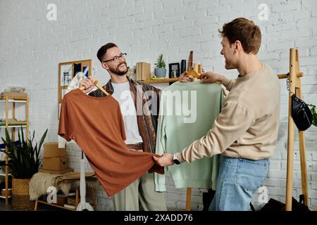 Two men in designer attire stand side by side, discussing ideas for their latest project in a trendy workshop. Stock Photo