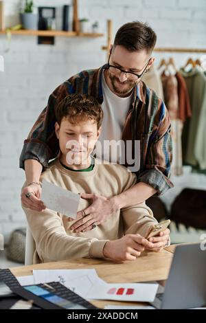 Two men in designer atelier, working together on laptop Stock Photo