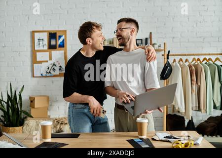 A gay couple collaboratively designs trendy attire in their designer workshop. Stock Photo