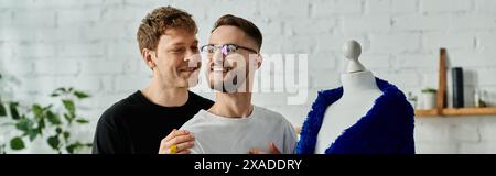 Two men with a mannequin in a designer workshop. Stock Photo