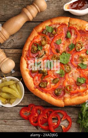 Delicious pizza Diablo and ingredients on wooden table, flat lay Stock Photo