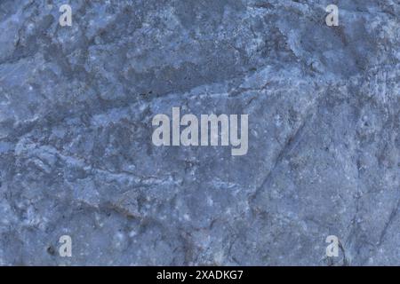 flat photography of a blue grey granite stone with cracked textured surface Stock Photo