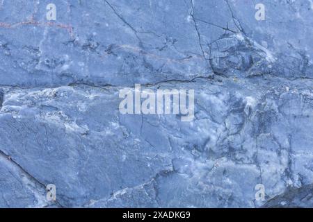 flat photography of a blue grey granite stone with cracked textured surface Stock Photo