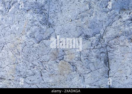flat photography of a light blue grey granite stone with cracked textured surface Stock Photo
