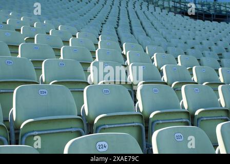 A row of empty seats in a stadium. The seats are numbered from 232 to 243 Stock Photo