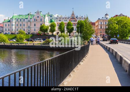 Vyborg, Russia - May 27, 2024: Vyborg old town street view photo taken on a sunny day, people walk the Fortress Bridge Stock Photo