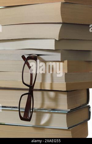 Stack of books with reading glasses Stock Photo