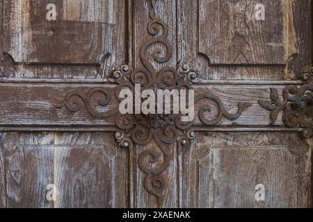 close-up photography of an old painted softwood textured door with ancient decorated rust metal knob Stock Photo