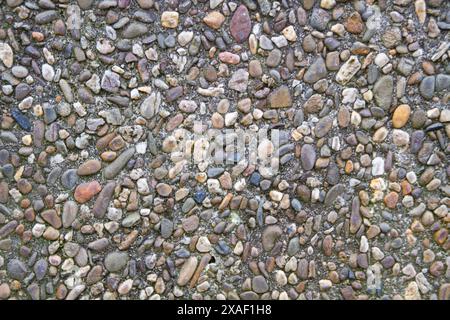 Small stone wall background in grey, yellow and beige colors with dark border Stock Photo