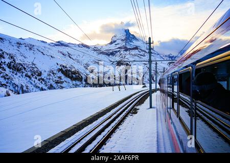 View of the Matterhorn from a window of the cogwheel train of the Gornergrat Railway descending towards Zermatt in the Swiss Alps in winter, Canton of Stock Photo