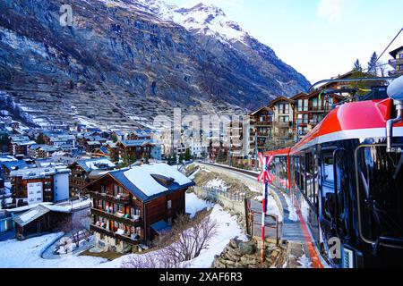 Cogwheel train of the Gornergrat Railway arriving in Zermatt in the Swiss Alps in winter, Canton of Valais, Switzerland Stock Photo