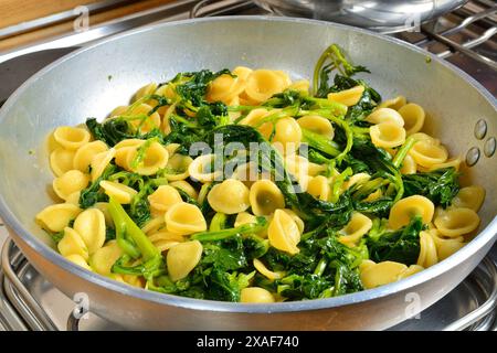 'Orecchiette con le cime di rapa': Italian pasta seasoned with broccoli rabe and anchovy. Stock Photo