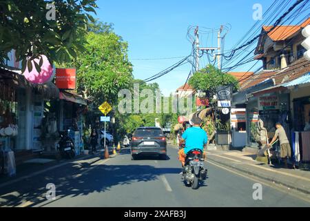 Ubud, Bali in Indonesia - January 31 2024: Cars and motobikes drive on the streets of Bali Stock Photo