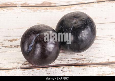 Two ripe sweet black plums isolated Stock Photo